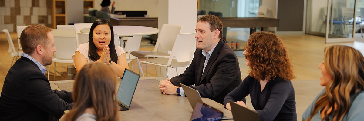 First American colleagues collaborating around a table in cafeteria