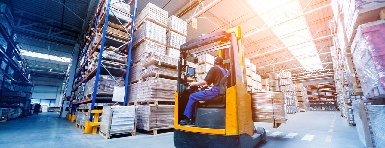 Man in warehouse with boxes/packages on the shelves