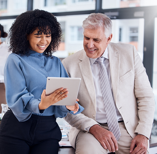 Man and woman collaborating on a tablet