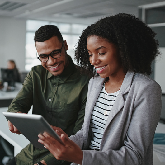 Man and woman collaborating on a tablet