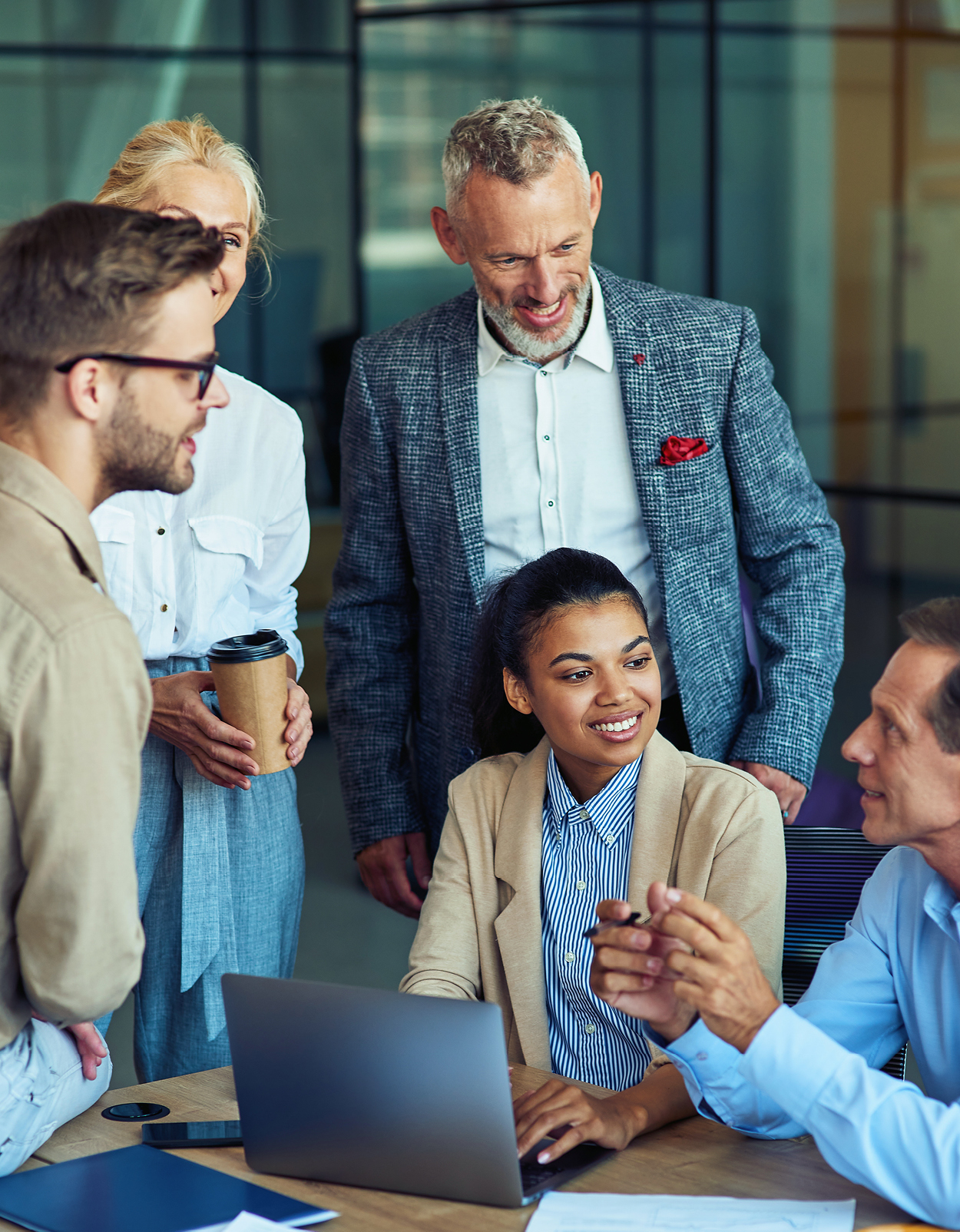 Colleagues collaborating at desk.