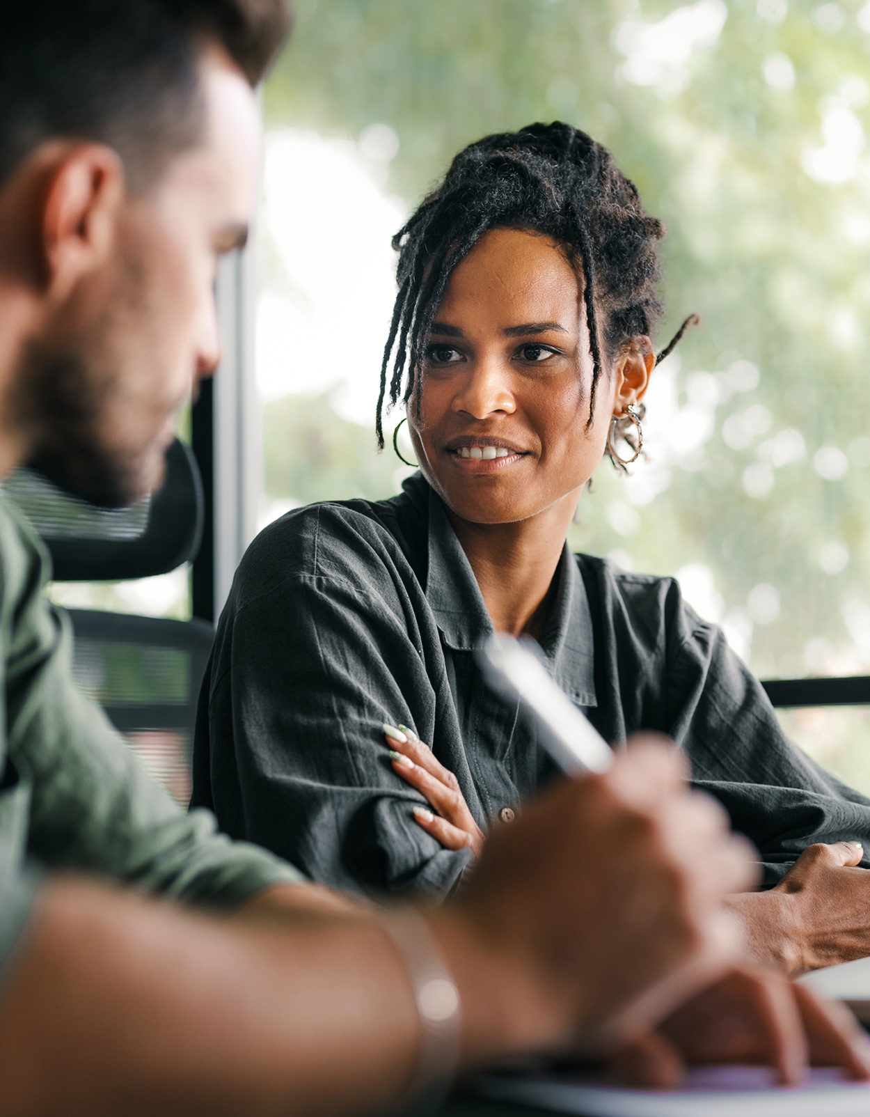 Woman and man collaborating at desk.