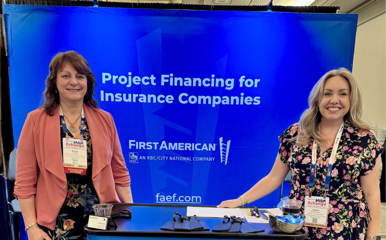 Two First American colleagues at a conference.