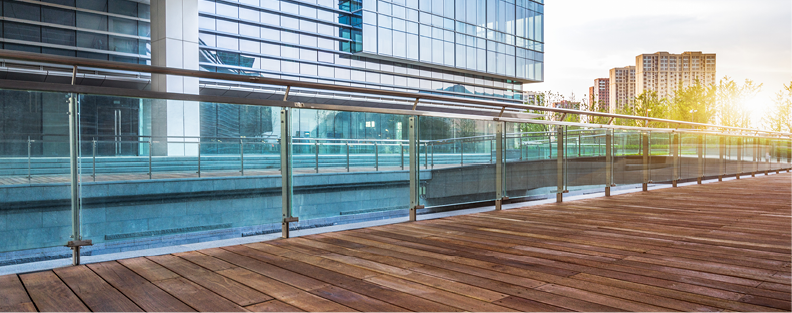 Outdoor office terrace with cityscape and sunlight.