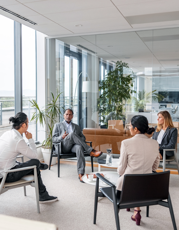 Small group meeting in a modern office lounge.