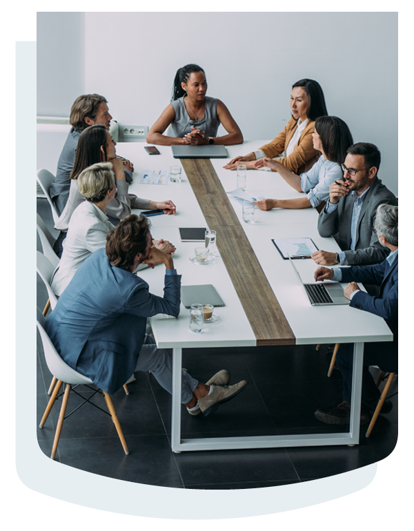 Employees collaborating in the office sitting around a table.