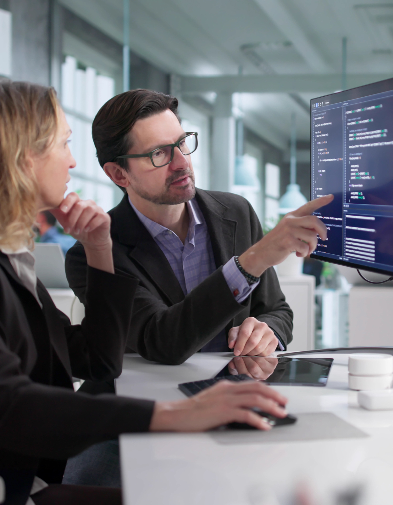 Two business colleagues collaborating on desktop.