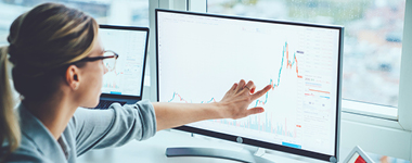 woman on laptop financial graph
