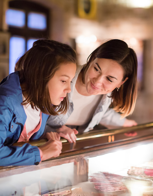 Young girl and woman visit museum together