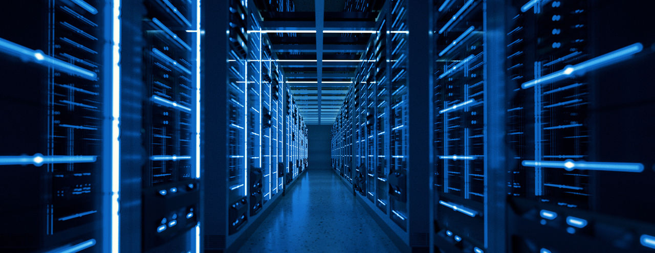 Data center with rows of serve racks on both sides, illuminated by LED lights.