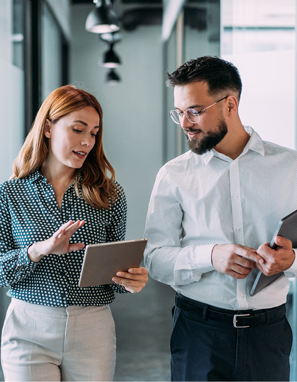 two coworkers smiling on tablet