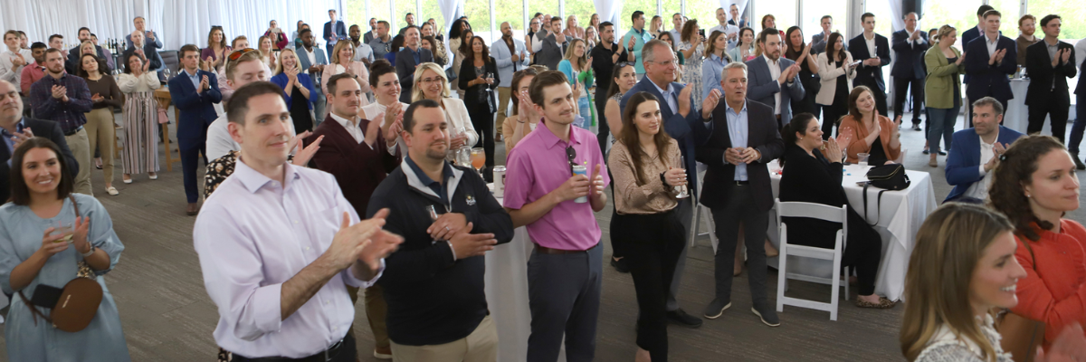 Colleagues clapping at an event