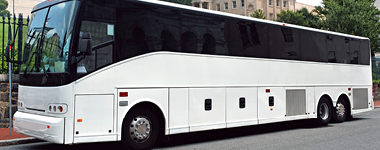 Parked white tour bus on the edge of the street