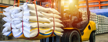 Forklift transporting material in distribution center