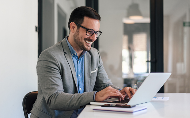 Man smiling on laptop