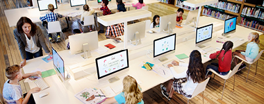 Students in K12 school working on laptops