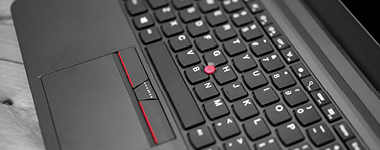 Black laptop keyboard trackpoint red dot cap and touchpad with buttons