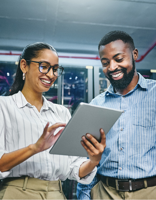 two coworkers smiling on tablet