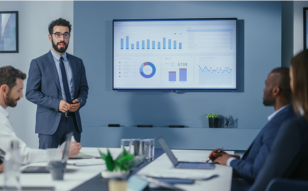 Business professional giving presentation with graphs and charts