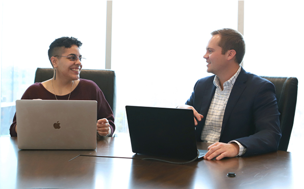 First American colleagues collaborating and smiling at table